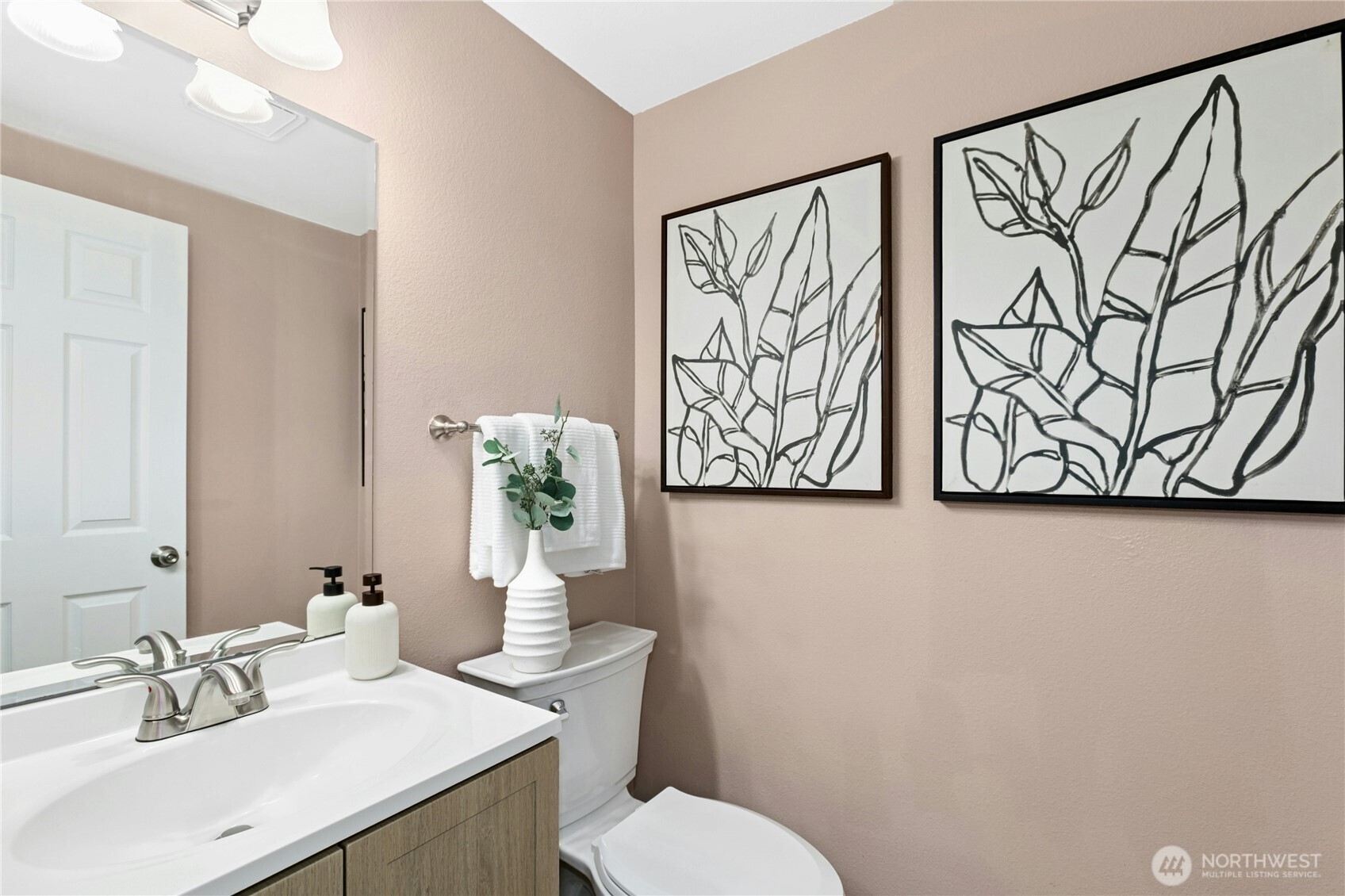 Guest bath, hall bath, call it what you'd like. A convenient half bath on the main floor. New vanity, flooring, and lighting.