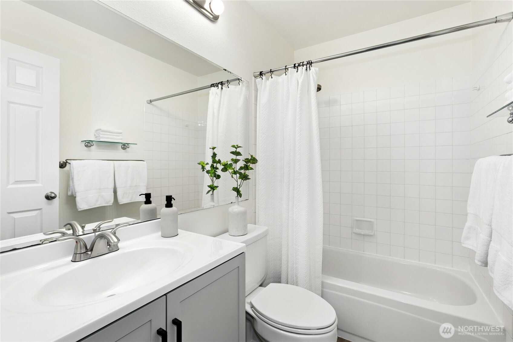 Step into the primary ensuite, take a bath, and enjoy the new vanity, floors, and lighting.