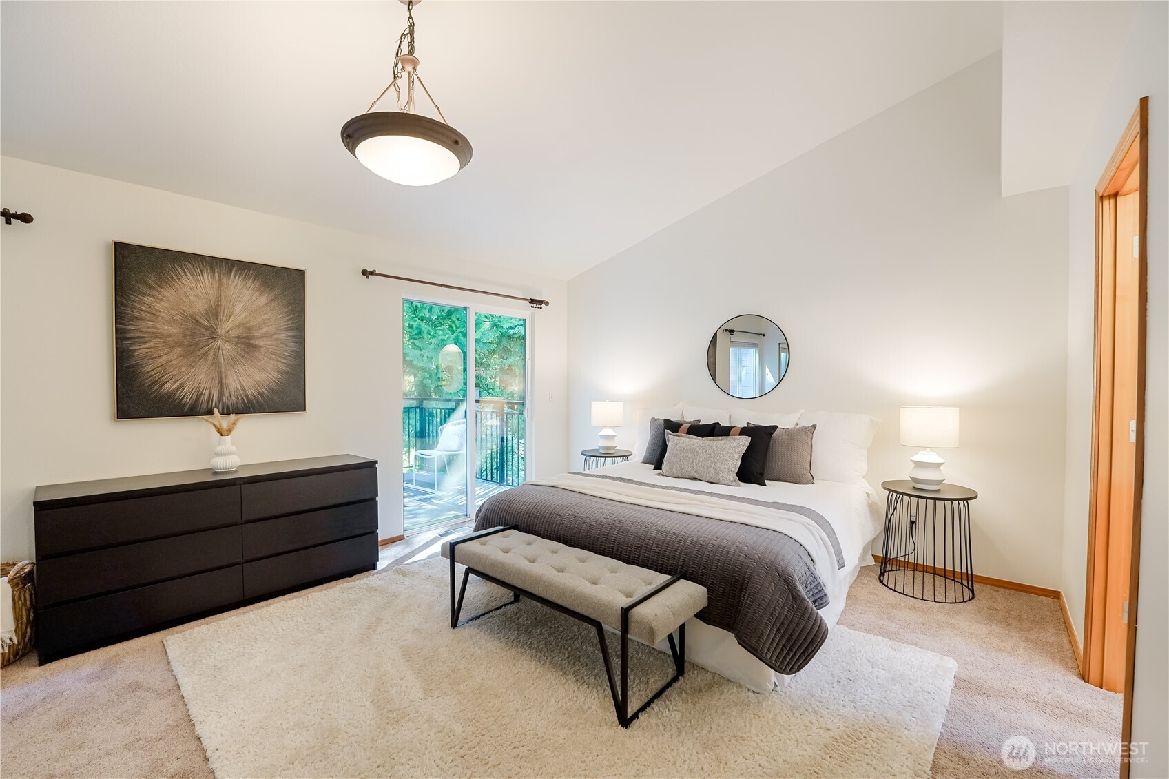 Giant primary suite with deck, closets, vaulted ceilings, and en suite with skylight.