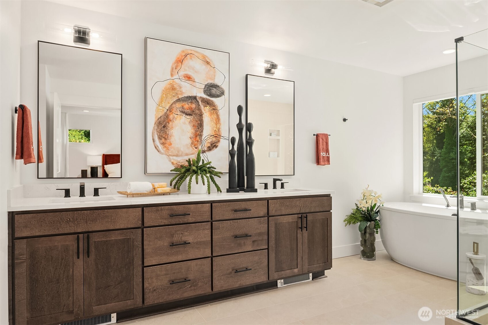 Spa like primary bath with free standing tub and large tile shower with frameless glass enclosure