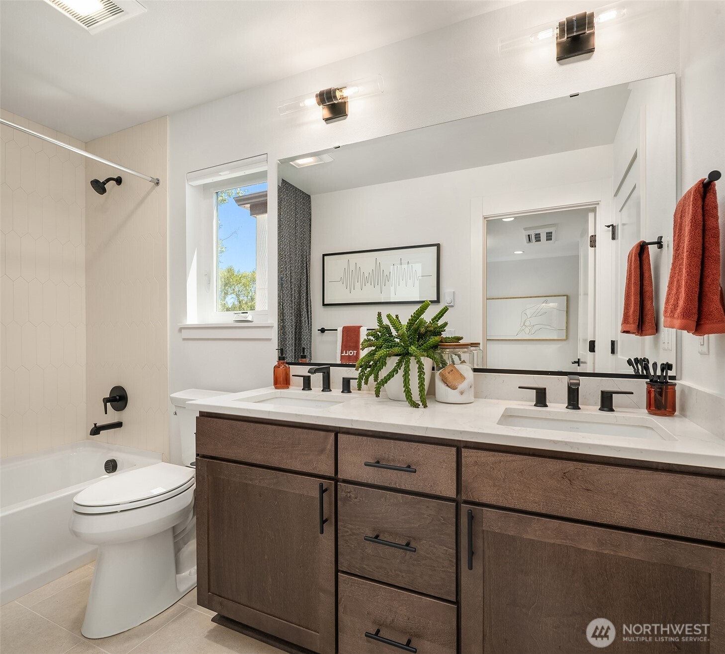 Continental bath with dual sinks, quartz countertops, tub with designer tile surround