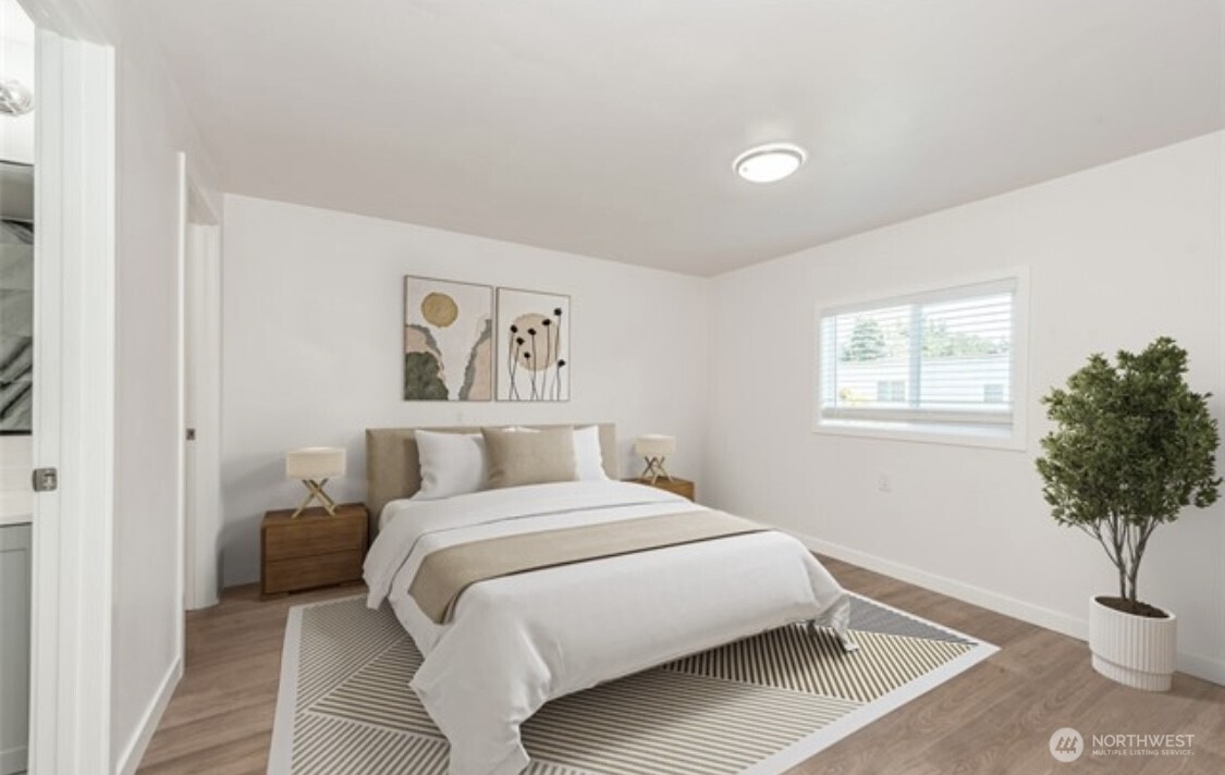 The spacious primary bedroom offers a serene retreat with plenty of natural light and a generous walk-in closet for all your storgae needs.