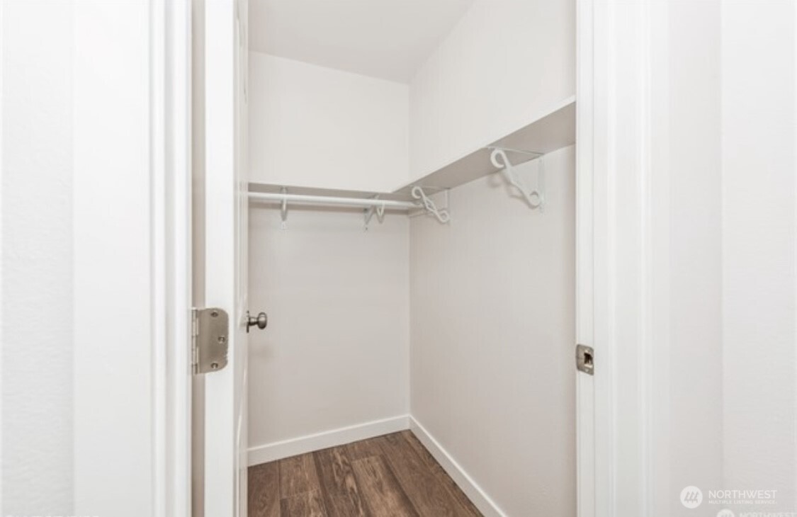 The primary suite features a large walk-in closet, providing ample space for storage