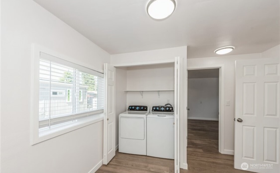 Convenient laundry area tucked inside a closet, keeping things neat and easily accessible.