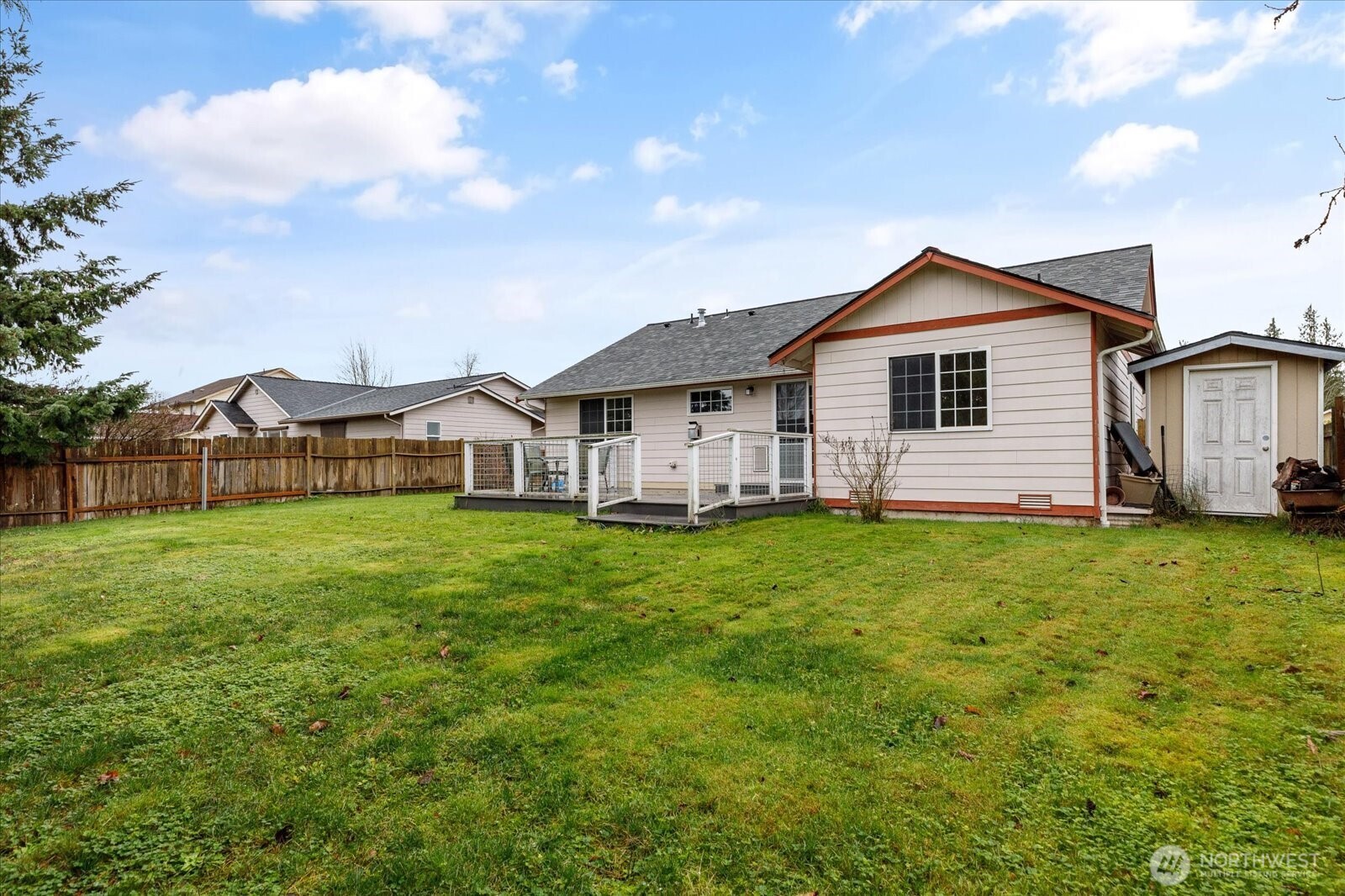 Fully fenced, level backyard with a shed perfect for gardening or outdoor activities.