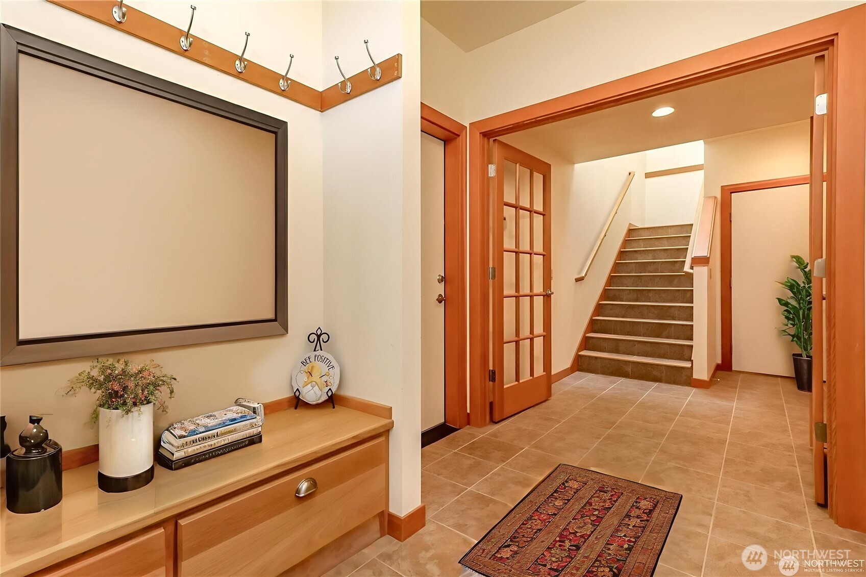 Front entrance with wide doors and tile floors.
