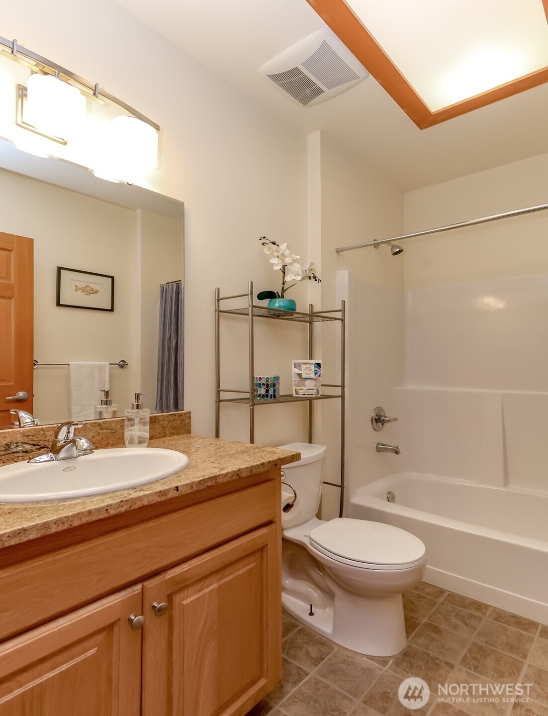 Main floor bathroom with wide door, skylight and bathtub