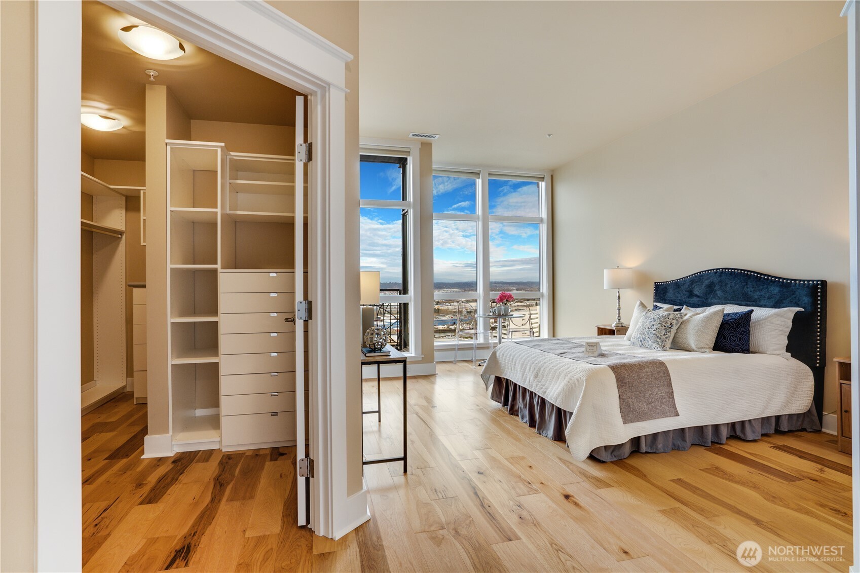 Main floor Primary Suite featuring private balcony & ensuite bath w/ heated flooring.