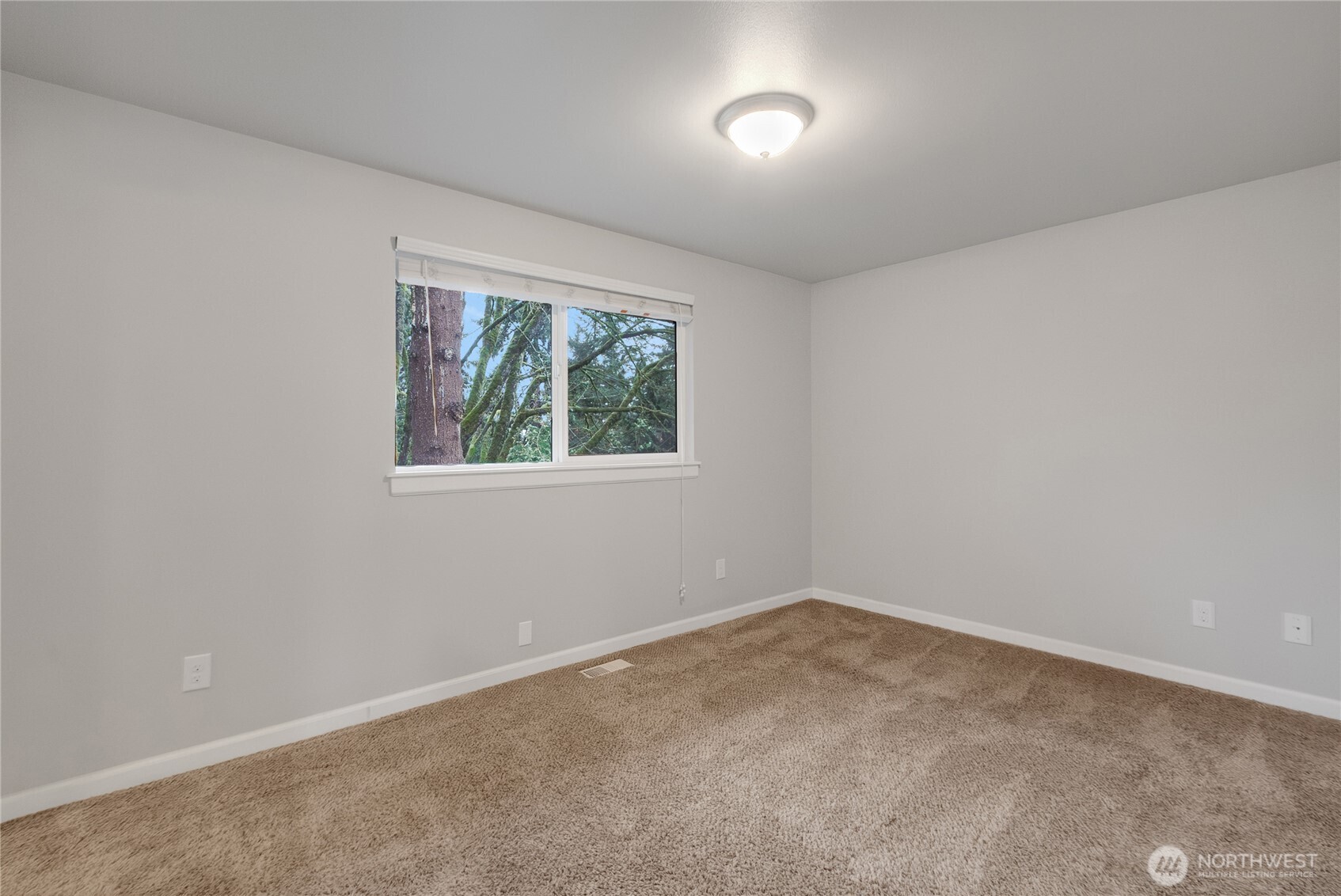 Primary Bedroom with a window facing the backyard.