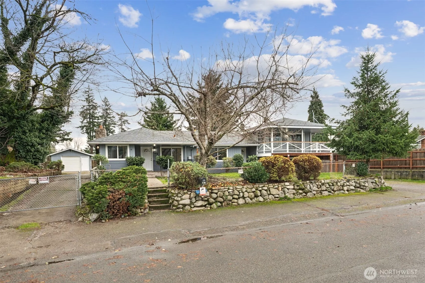 Two separate driveways and entrances- Left side is the 1-story portion with a detached shop/garage. Right side if the split-level portion with attached 1-car garage.