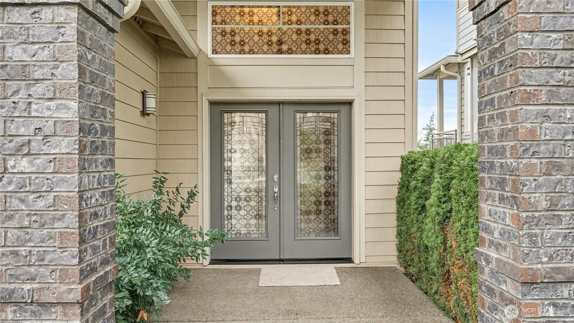 Enjoy stunning curb appeal with classic brick detailing & elegant double glass doors.