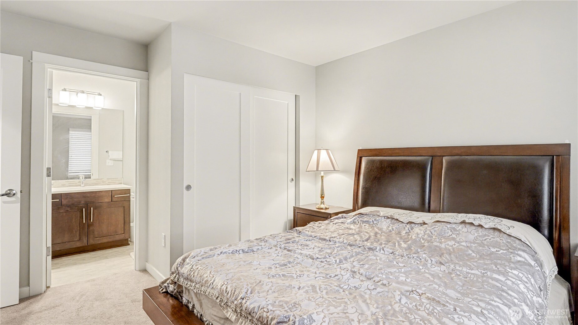 Another view of the downstair guest bedroom with sizable closet and en-suite full bathroom.