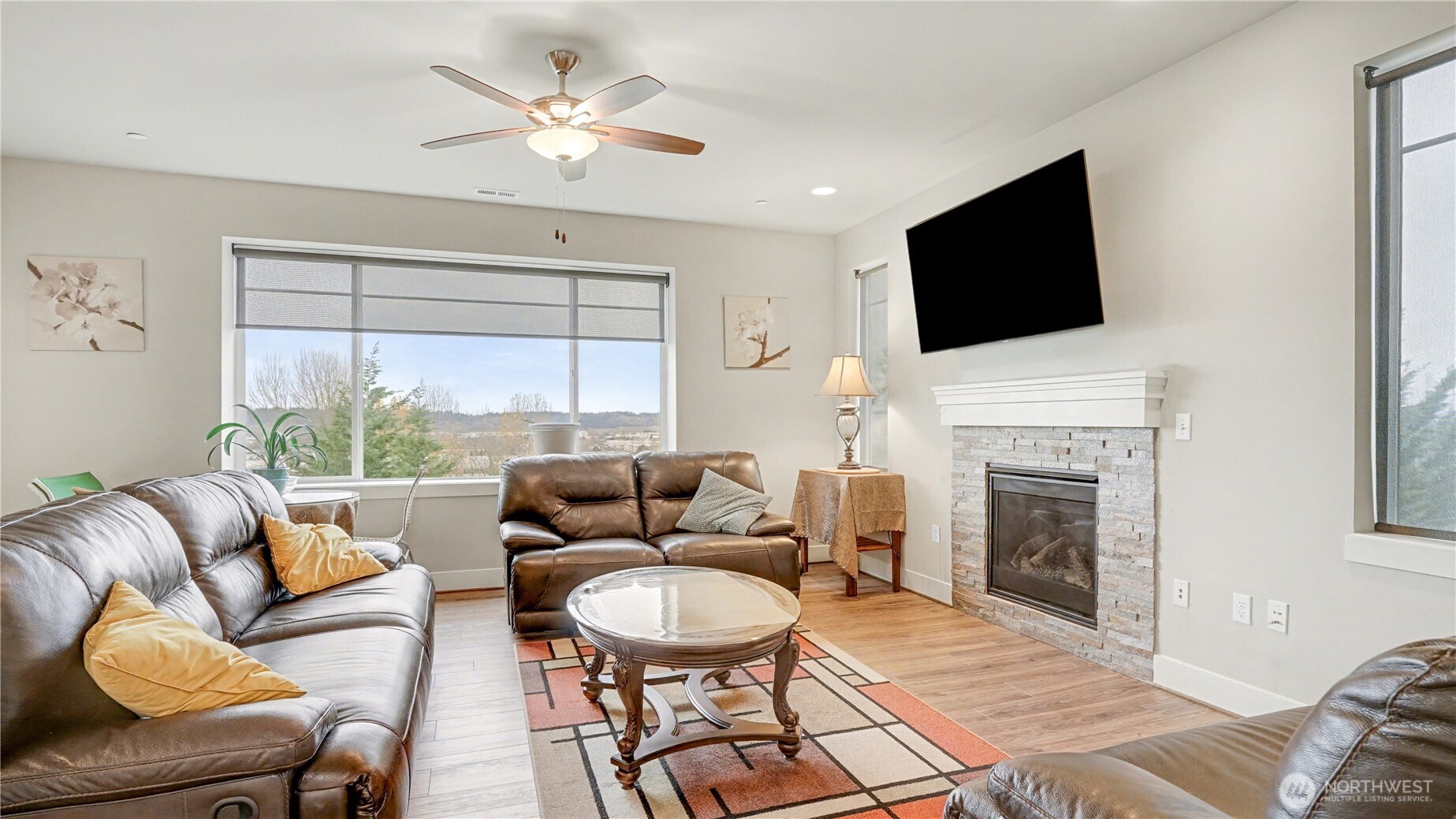 Open main level features a welcoming living area with a cozy fireplace.