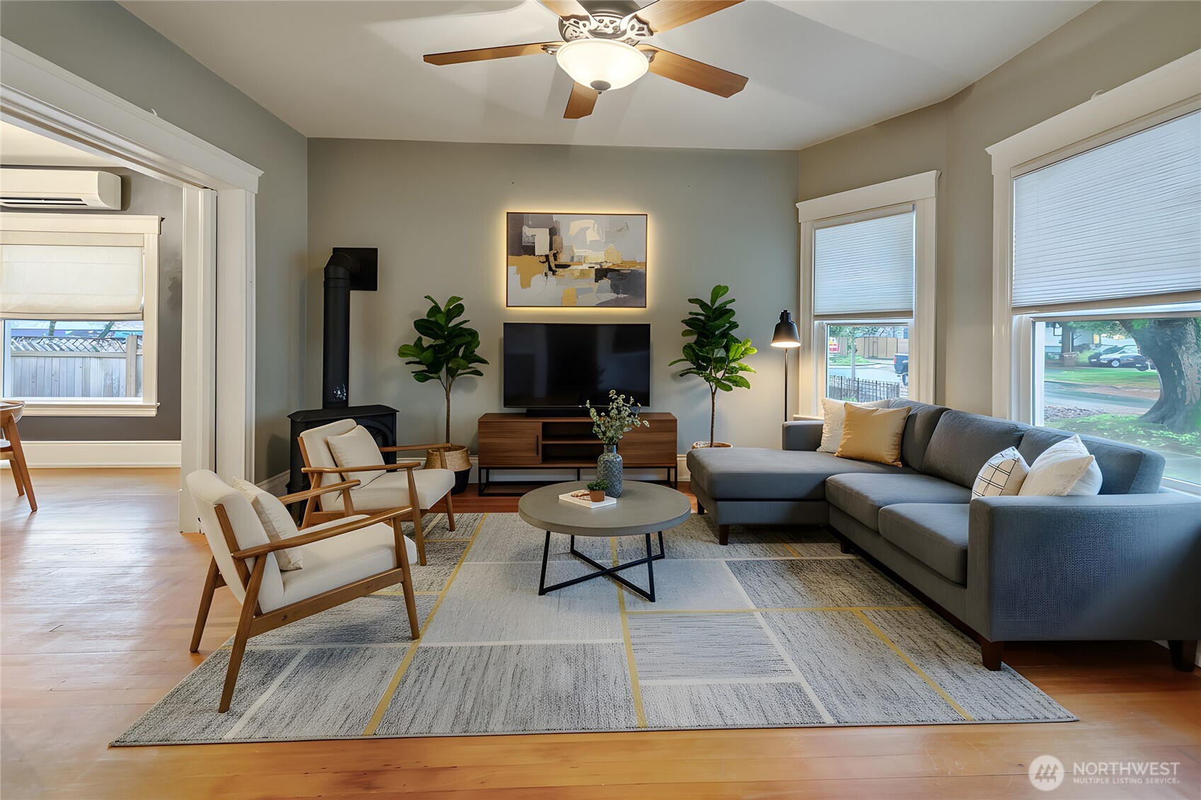 A daylit front living room to enjoy sunsets and the warm fireplace. *virtually staged