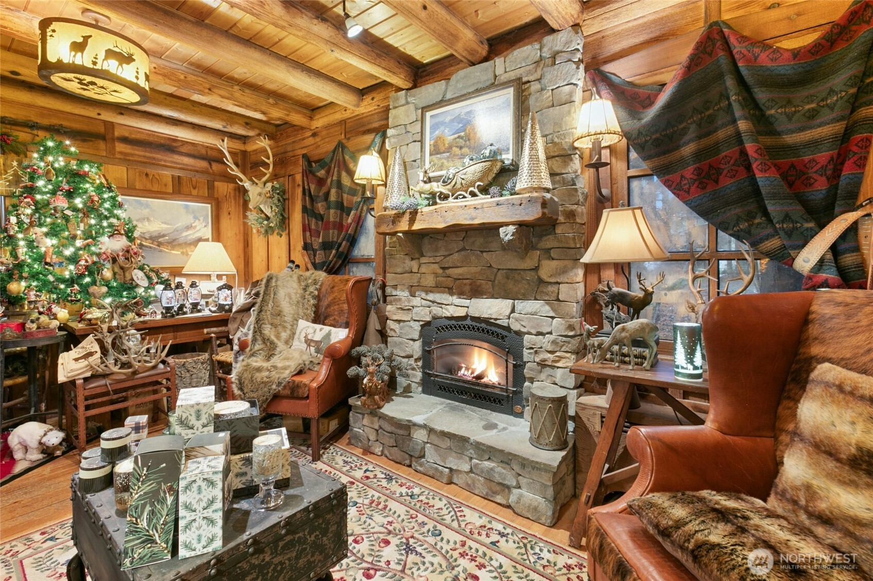 Famiy Room with stunning stone fireplace and reclaimed wood mantle, custom lighting and that beautiful log construction. (This area is currently part of the Active Business/shop)