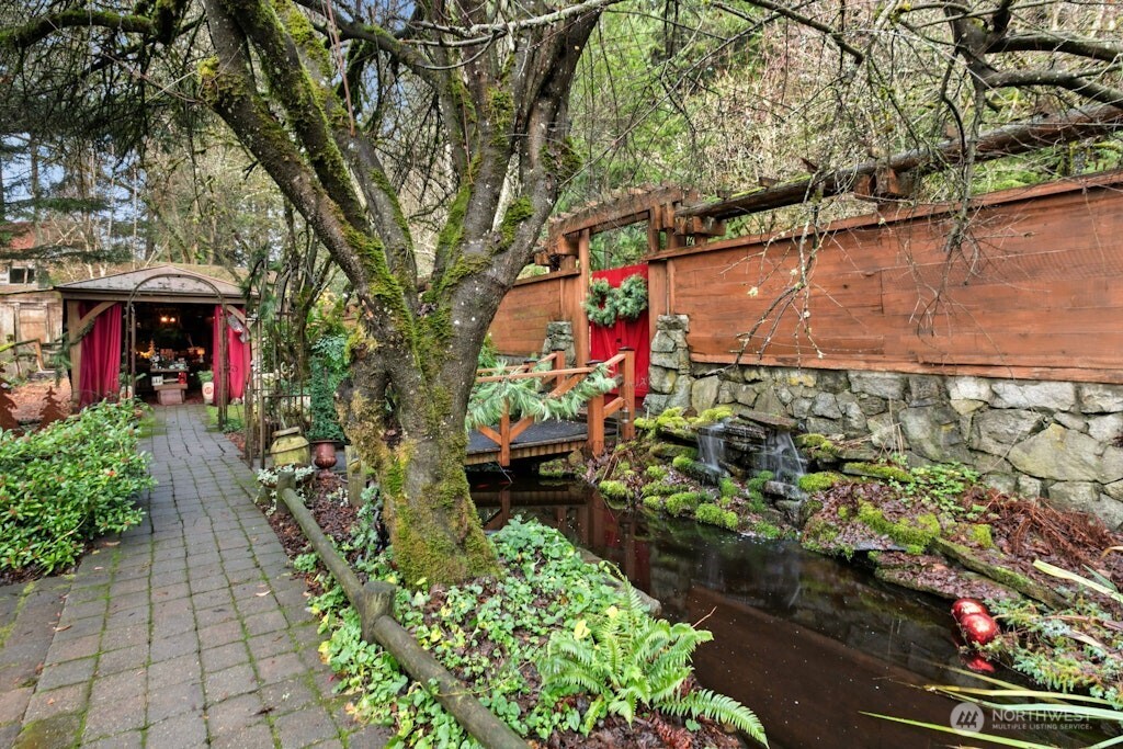 View of main gate entry and Koi pond/water feature and paver pathway