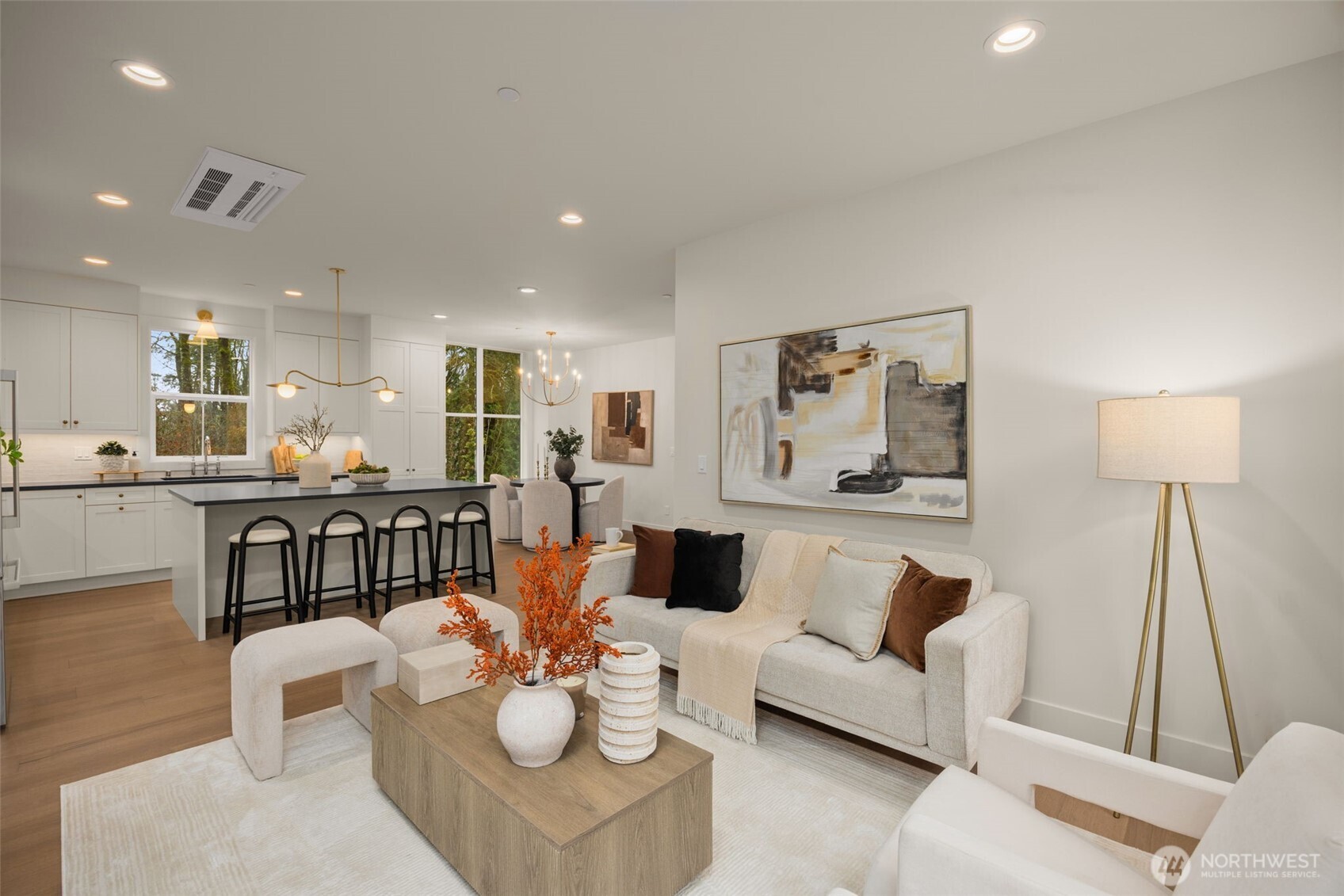 Living room open to kitchen and dining areas.