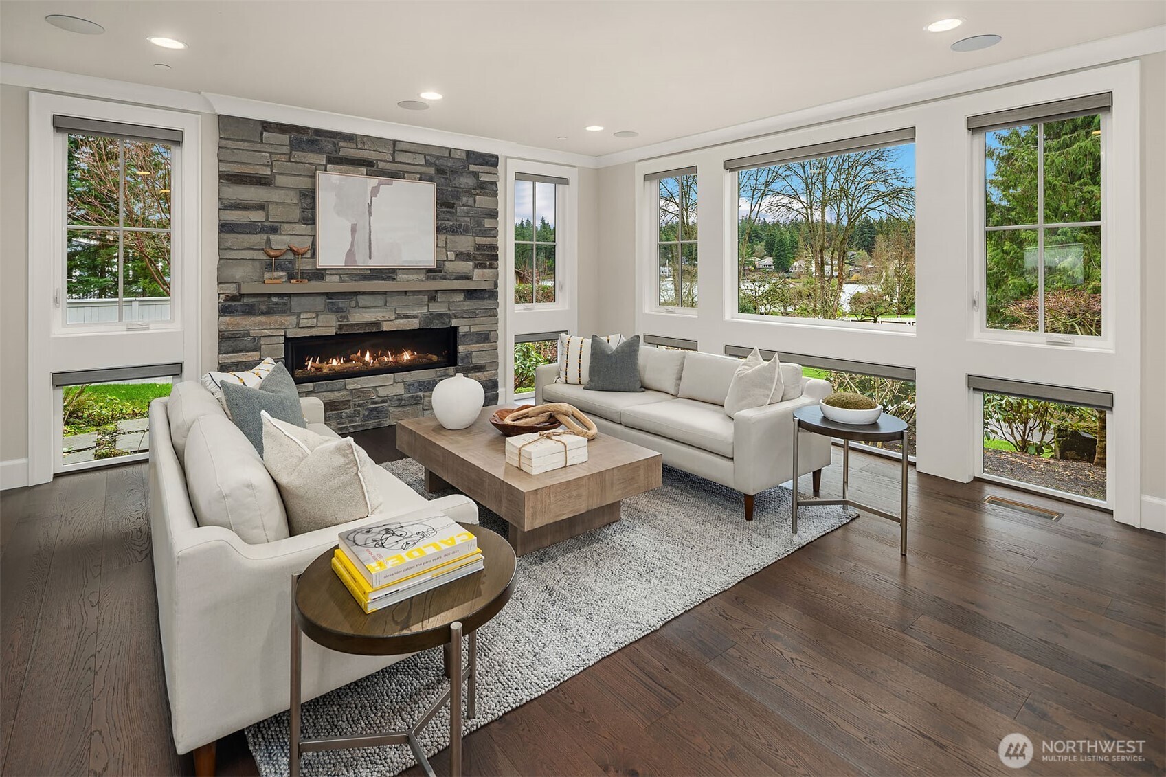 You’ll be surrounded by light in this living room.  All windows have custom electric blinds, so be prepared to enjoy views of Lake Washington from your favorite sofa.