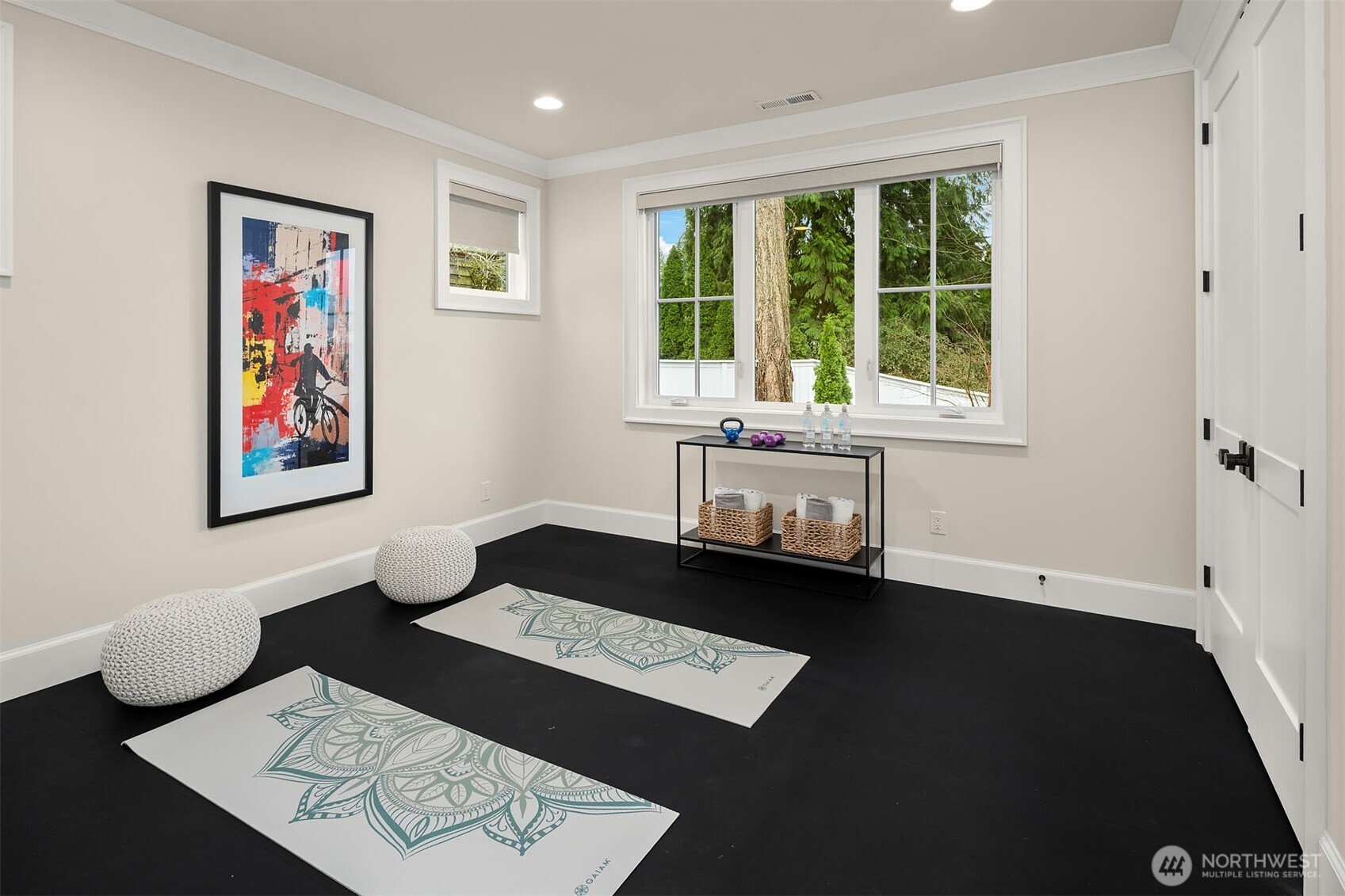 The fourth bedroom offers endless possibilities, making it a truly flexible space within the home. Currently, the mat floors create an ideal environment for a workout room or a yoga studio.