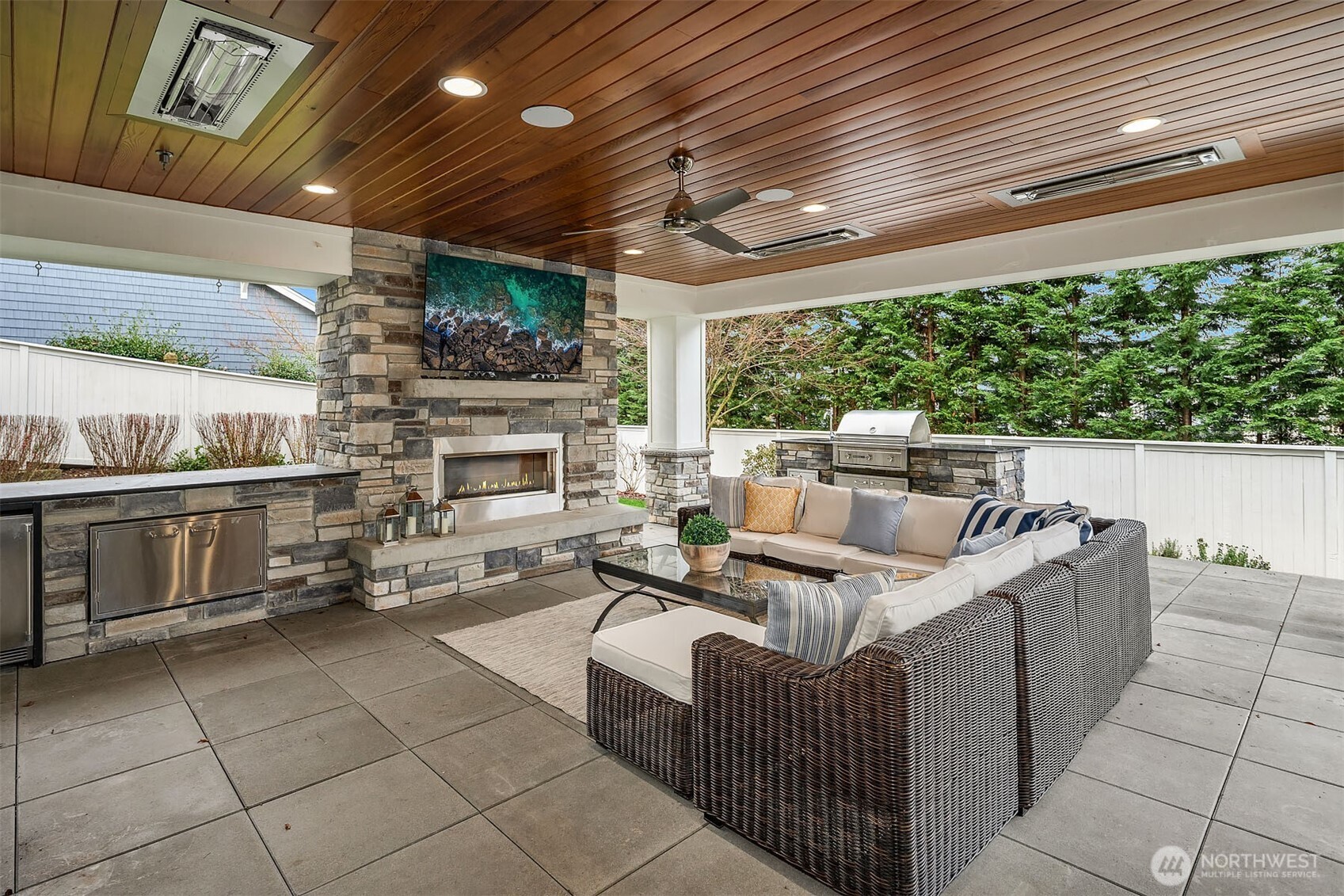 Enjoy an easy outdoor living space designed for comfort and convenience throughout the year. This area is equipped with four recessed heaters to keep you warm during cooler months, and a ceiling fan to provide a refreshing breeze in warmer weather. Gas fireplace, attached TV, and so much more.