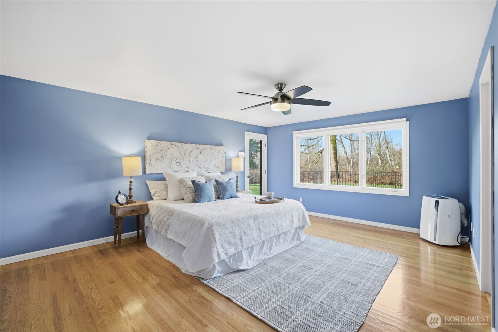 Spacious primary bedroom featuring private backyard access.