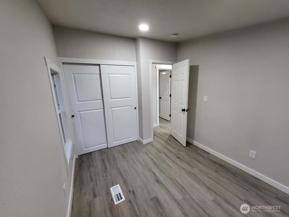 As promised; view from the corner between the 2 windows, showing off the closet in bedroom #3, featuring quiet, sliding doors and a super high ceiling inside! This is the last photo for now (12/23). More to come soon! Check back or come see it yourself!