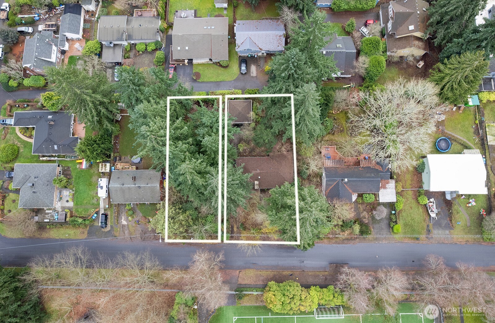 Aerial view of the home property showing the adjacent vacant lot.