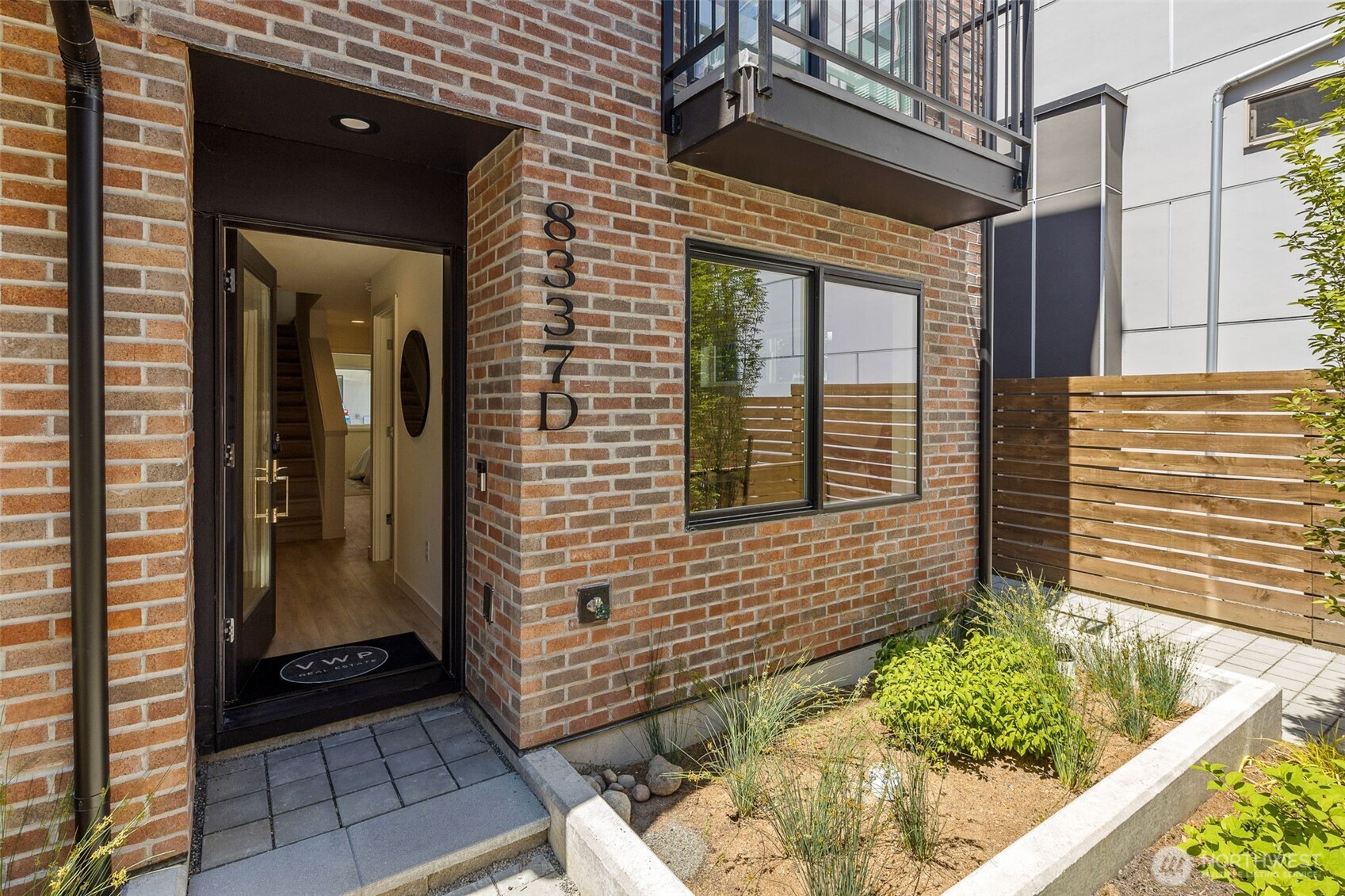 A warm brick entry with landscaped detail sets a gracious first impression.