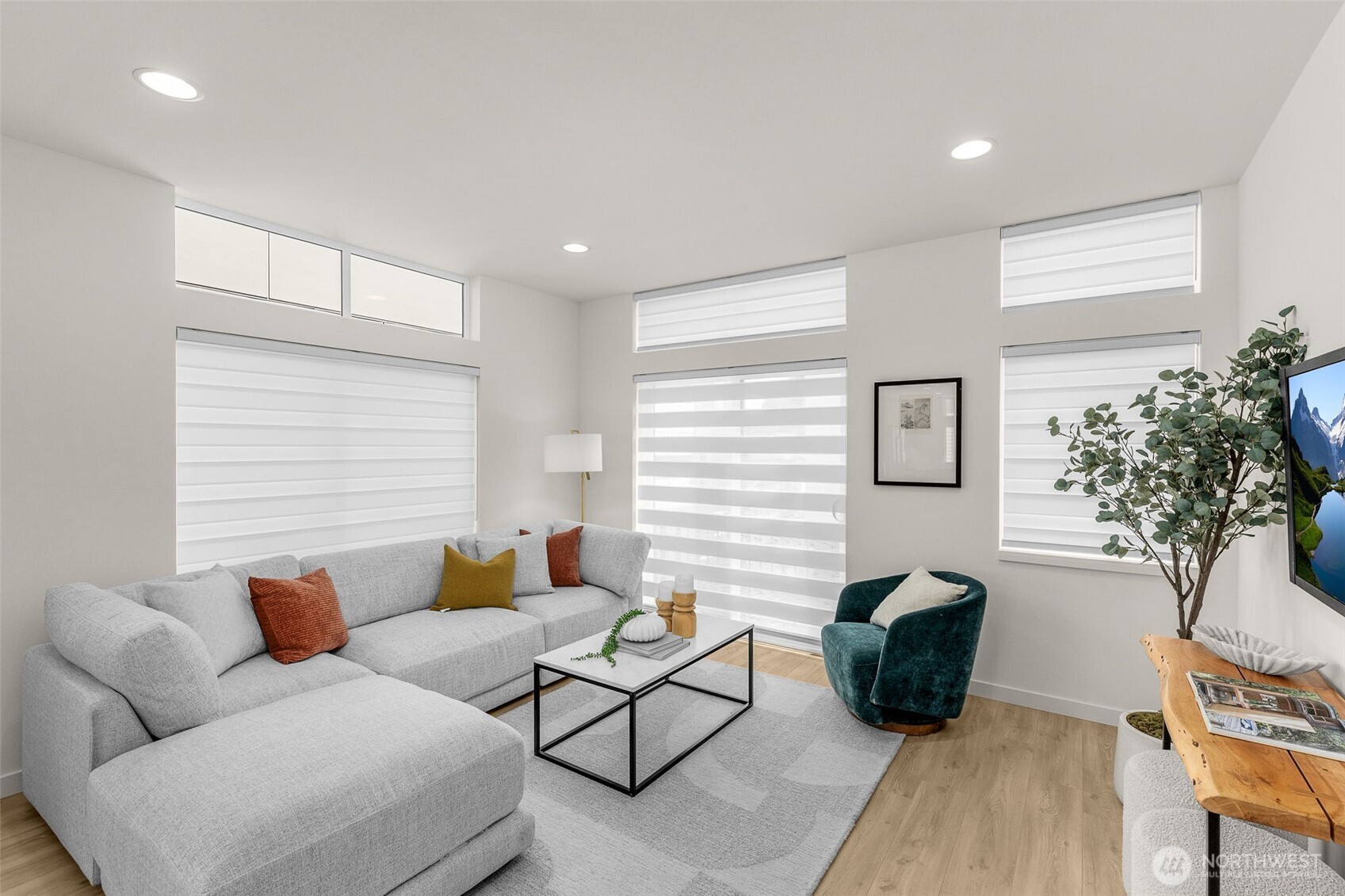 Bright corner living space framed by large windows creates an ideal spot to entertain.