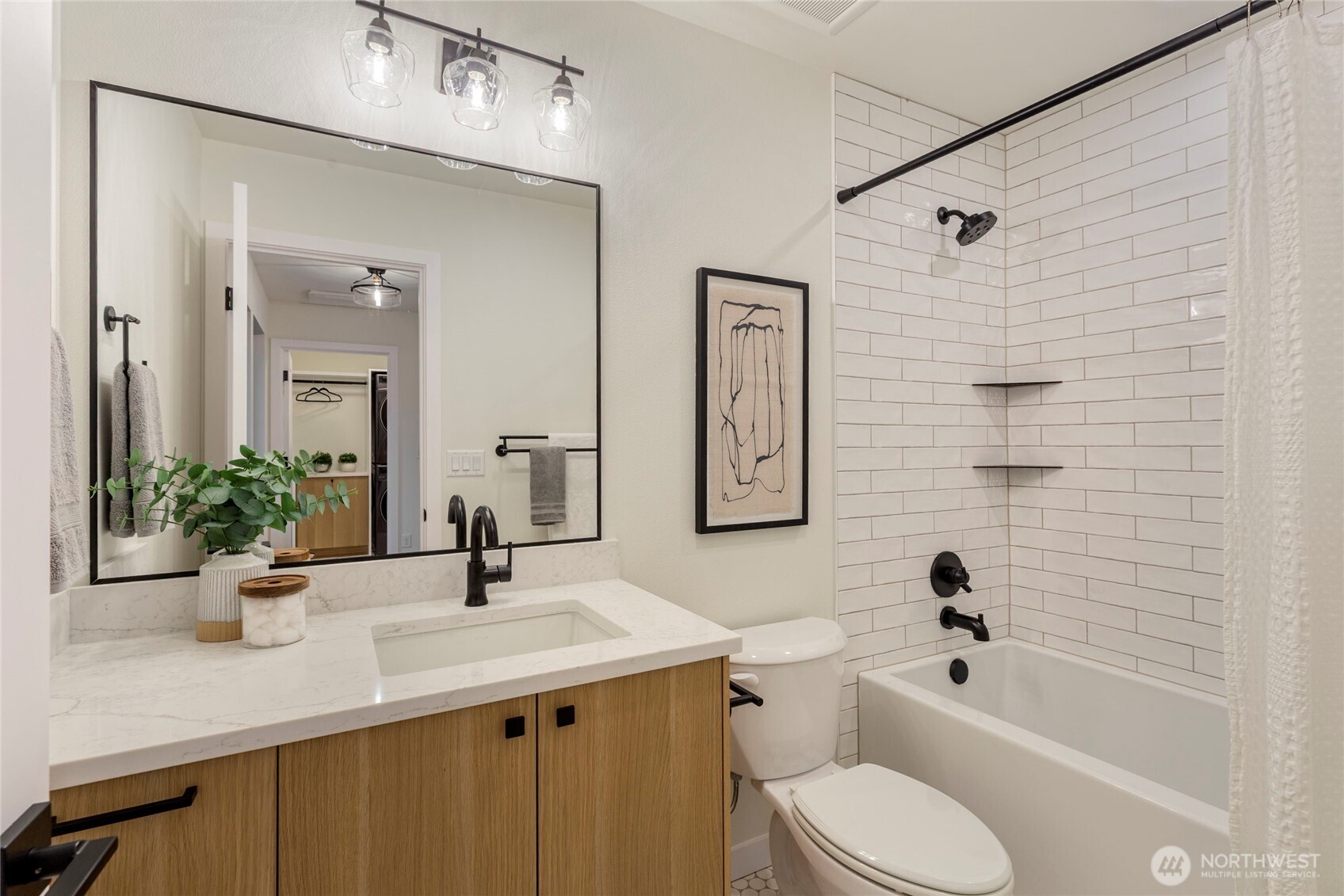 Full bath located on the second floor, tiled shower/bath with a quarts countertop sink.