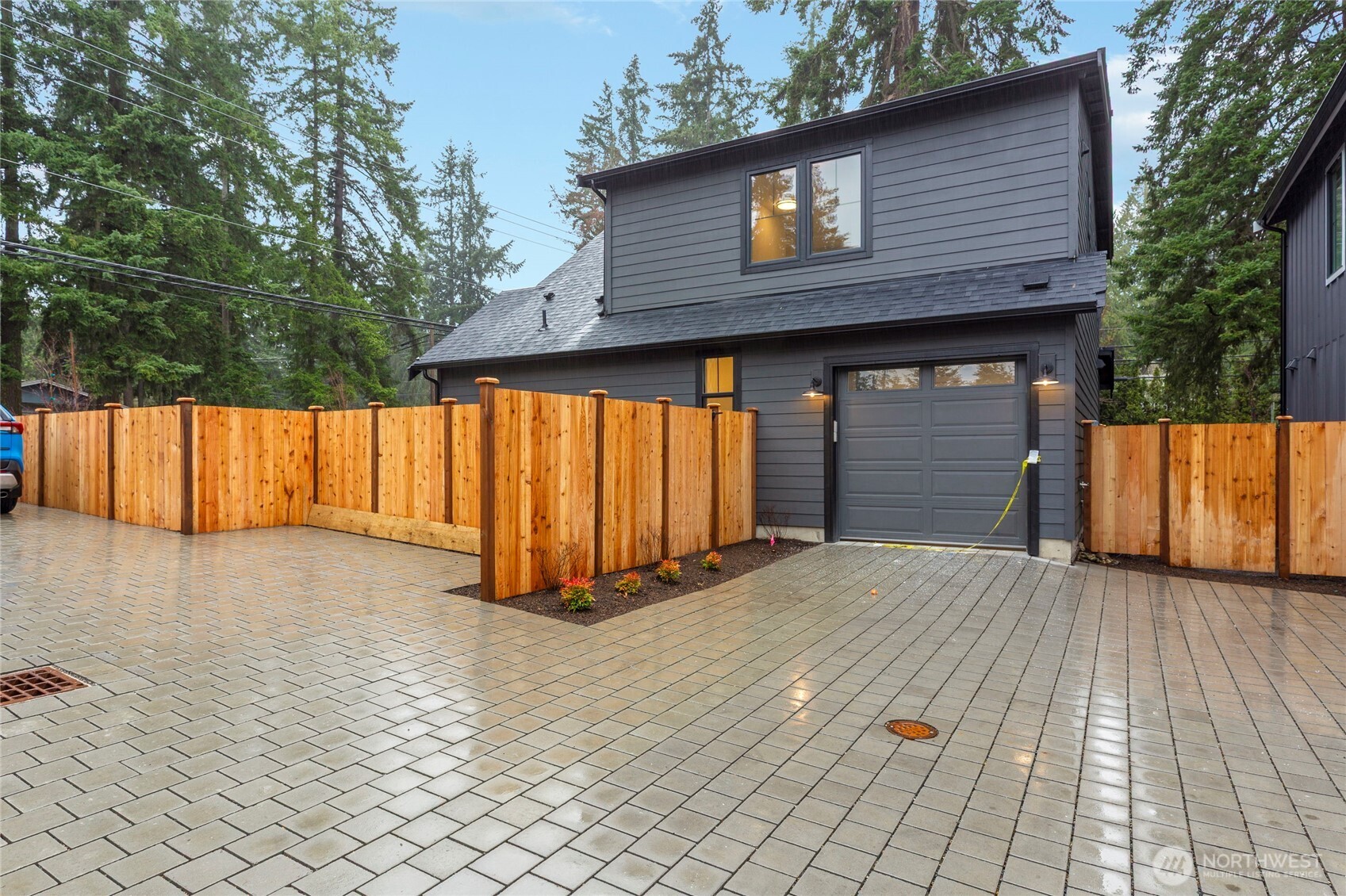 Garage with a dedicated parking pad to the right of it.