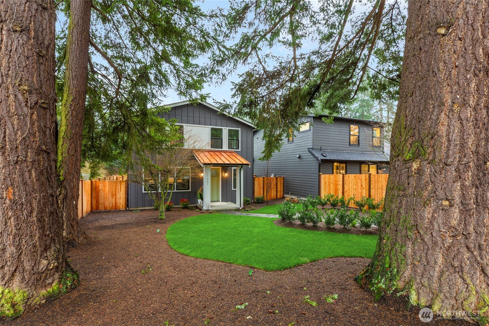 Fully landscaped with large mature trees and irrigated yard looking towards the front of the home.