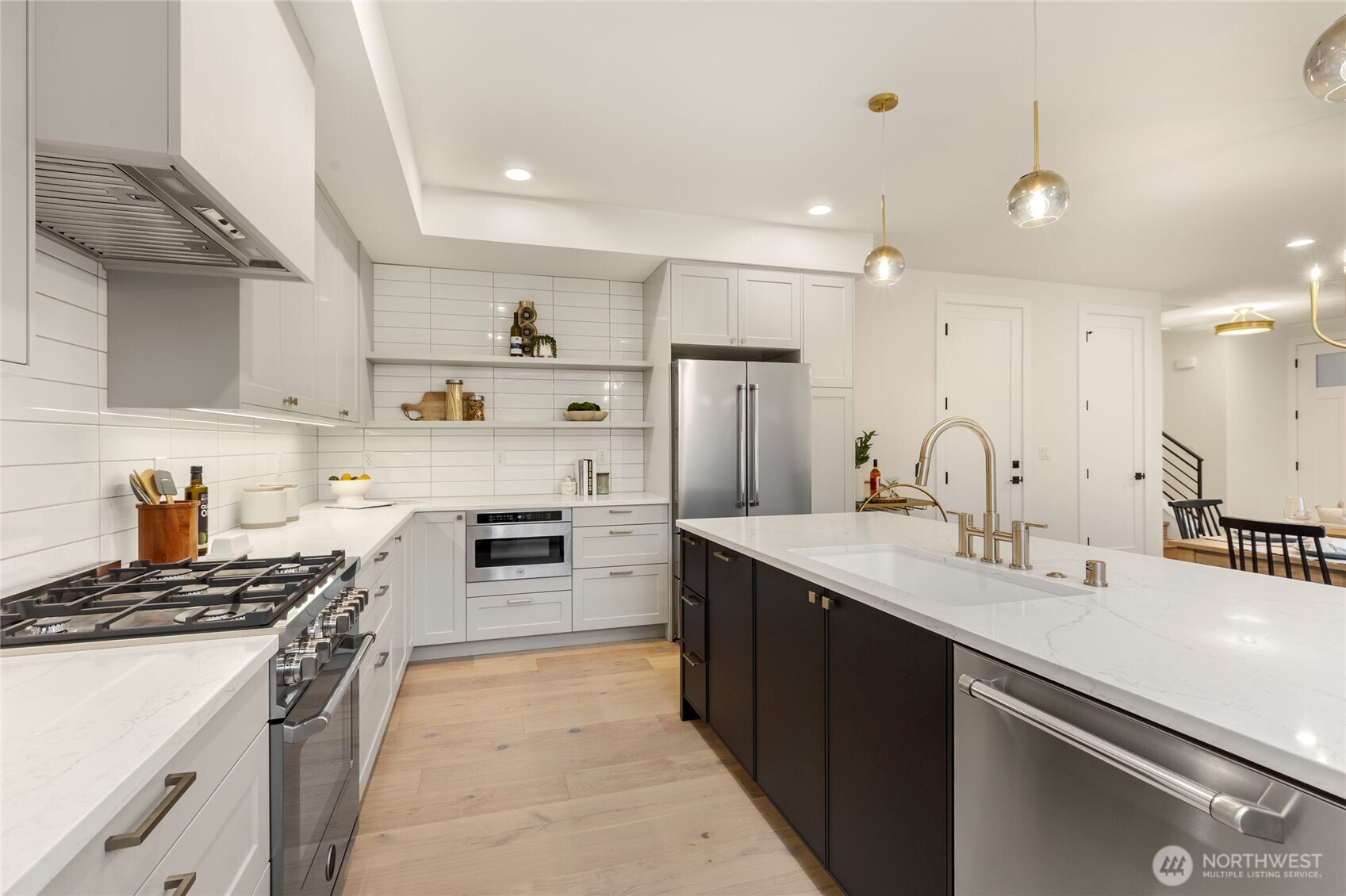 Bertazzoni microwave, oven, and dish washer, tucked along quartz counter tops.
