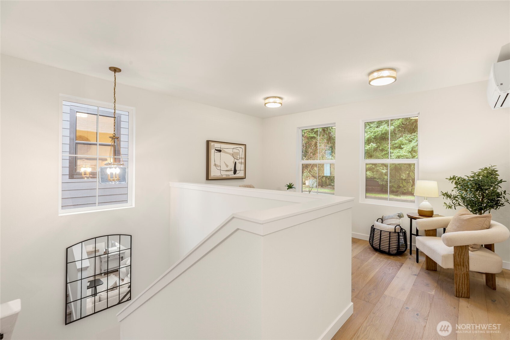Upstairs landing with pendant light, three windows, and a cozy seating nook.