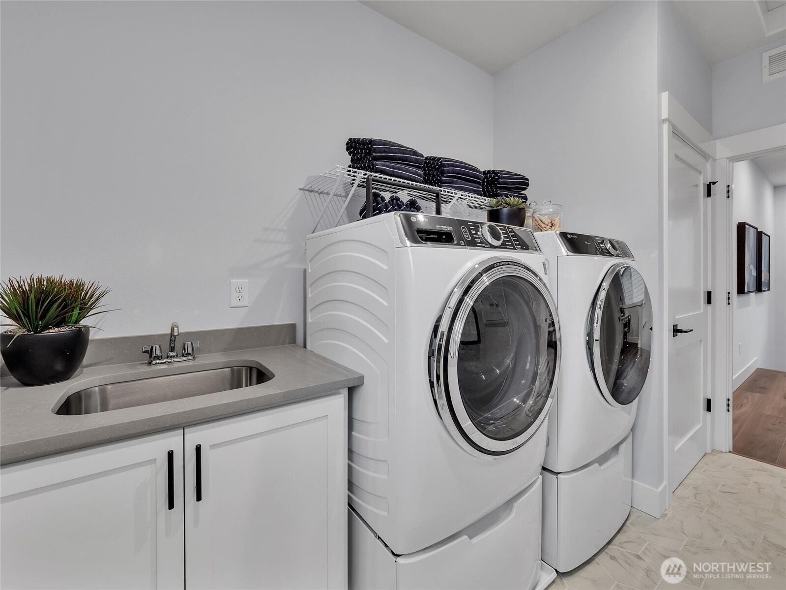 Generous laundry rm on 2nd floor with convenient utility sink.  Photo is of model home-Victorian plan-elements in the Chateau plan can vary