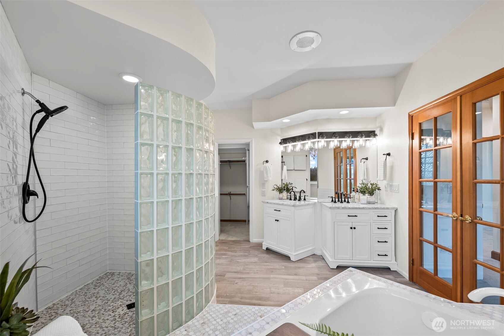 The newly renovated primary bathroom provides a spa-like experience