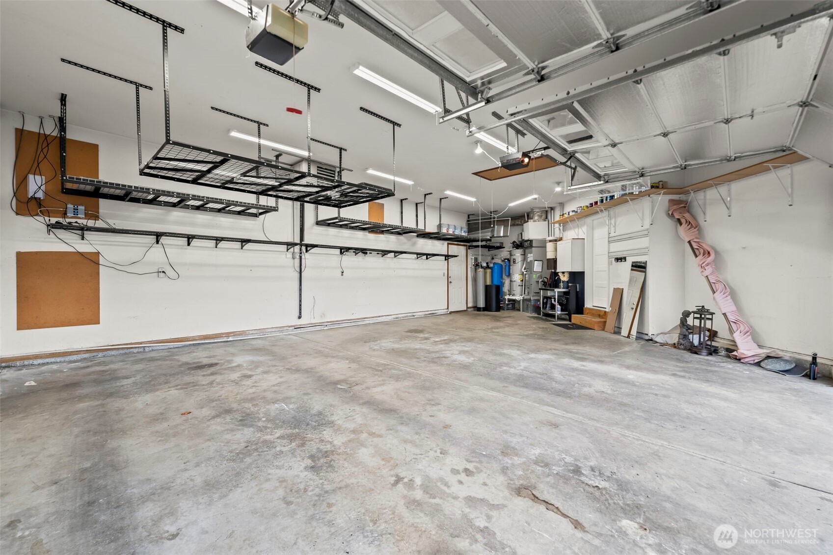 The three+ car garage is expansive, with plenty of overhead storage and a pull down ladder for attic access