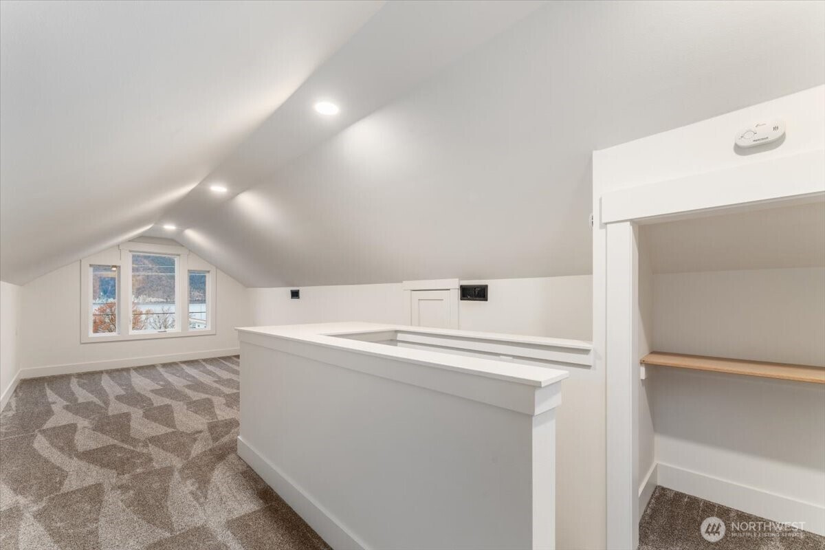 The second bedroom on the main floor is located just off the kitchen and dining area, to the left. To the right, you’ll find the dining area.