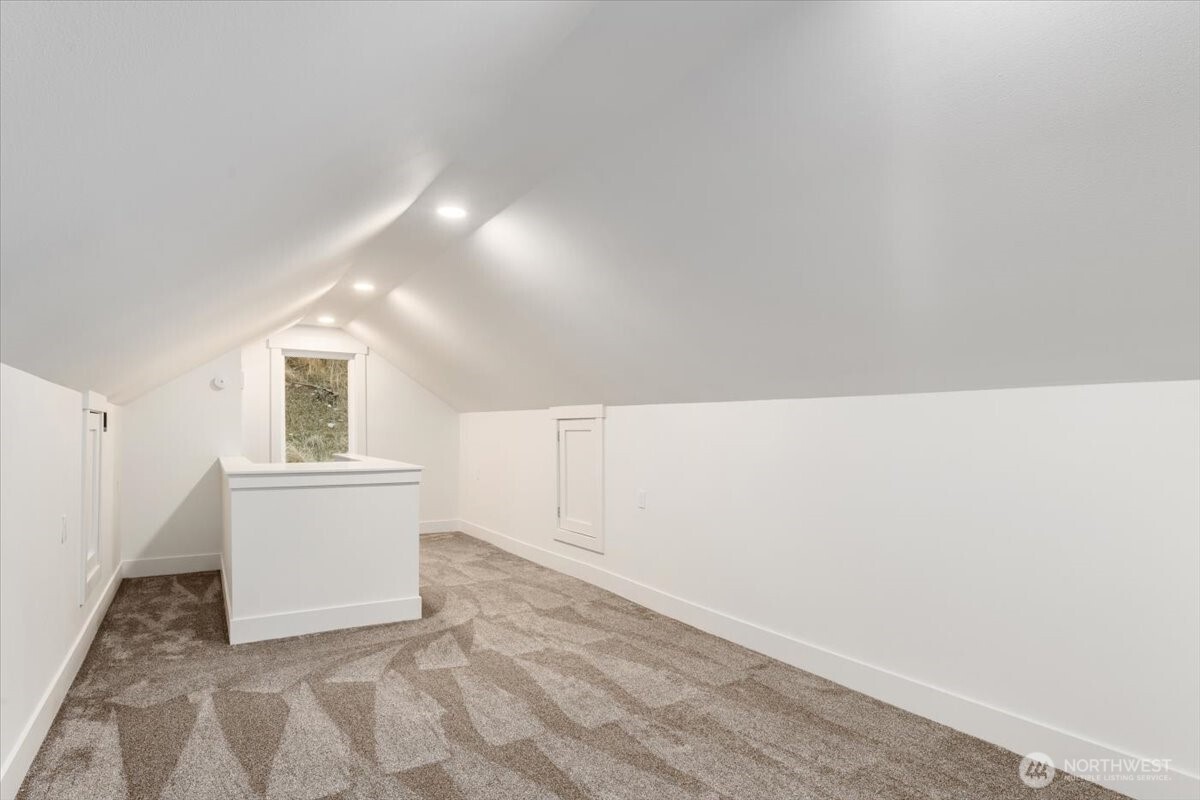 The second bedroom features the same updated finishes as the rest of the home, including modern light fixtures for a cohesive, refreshed look.