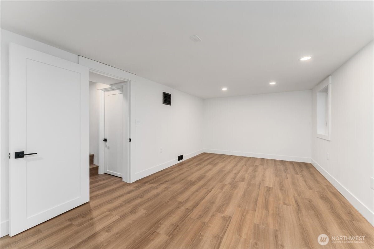 Next to the second bedroom is a half bathroom, conveniently equipped with new washer and dryer hookups for added ease and functionality.