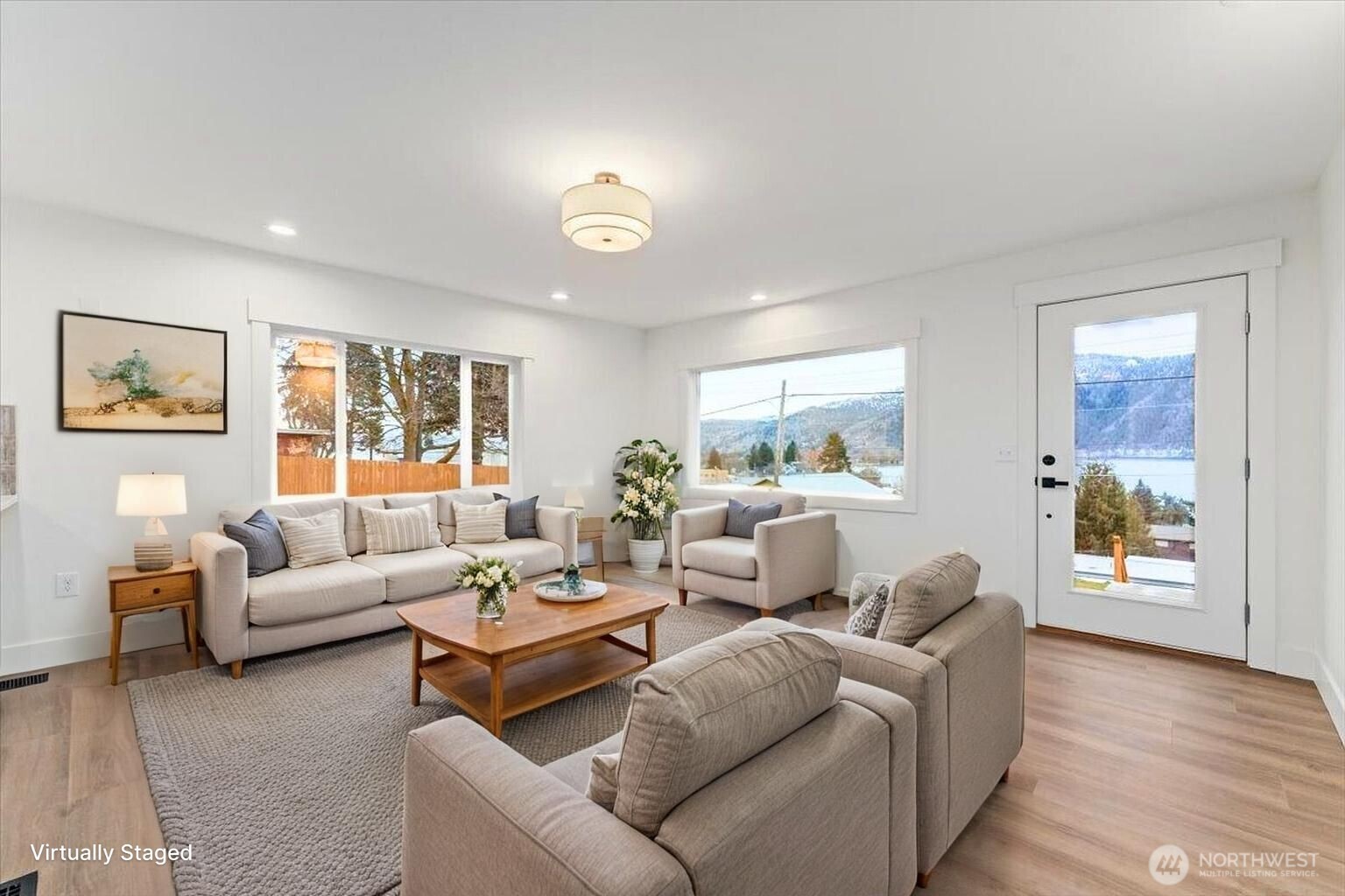 Virtually Staged - Step through the front door and experience the feel of a completely remodeled home, featuring new flooring, fresh paint, updated windows, and modern light fixtures throughout—creating a beautifully warm and welcoming space.