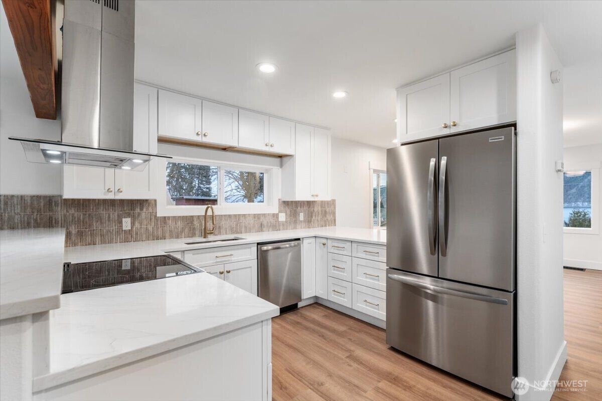 Step through the front door and experience the feel of a completely remodeled home, featuring new flooring, fresh paint, updated windows, and modern light fixtures throughout—creating a beautifully warm and welcoming space.