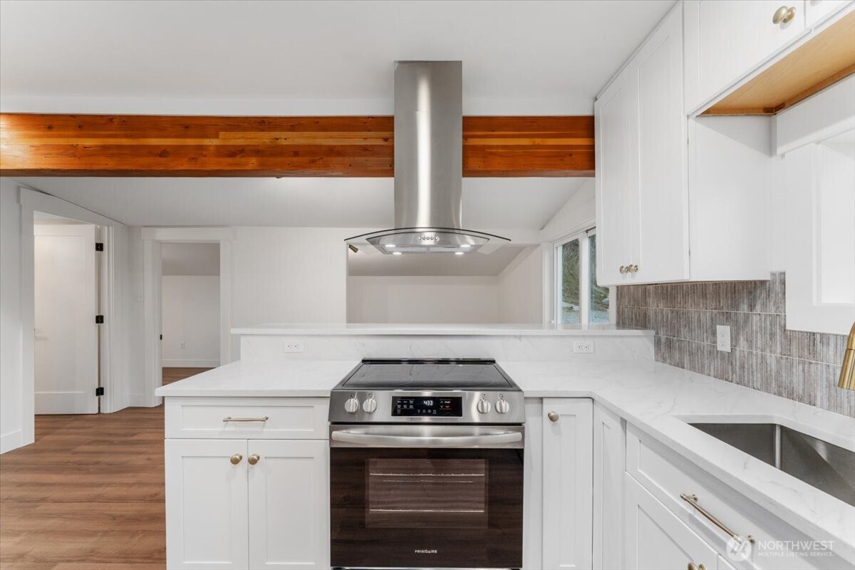 The living room features expansive windows that flood the space with natural light while framing the views from every angle—an inviting place to relax, gather, and create lasting memories with loved ones.