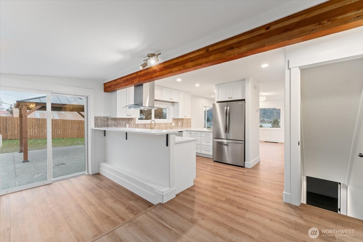 The kitchen has been completely remodeled with new stainless steel appliances, new cabinetry, updated countertops, and a stylish backsplash—bright, clean, and modern.