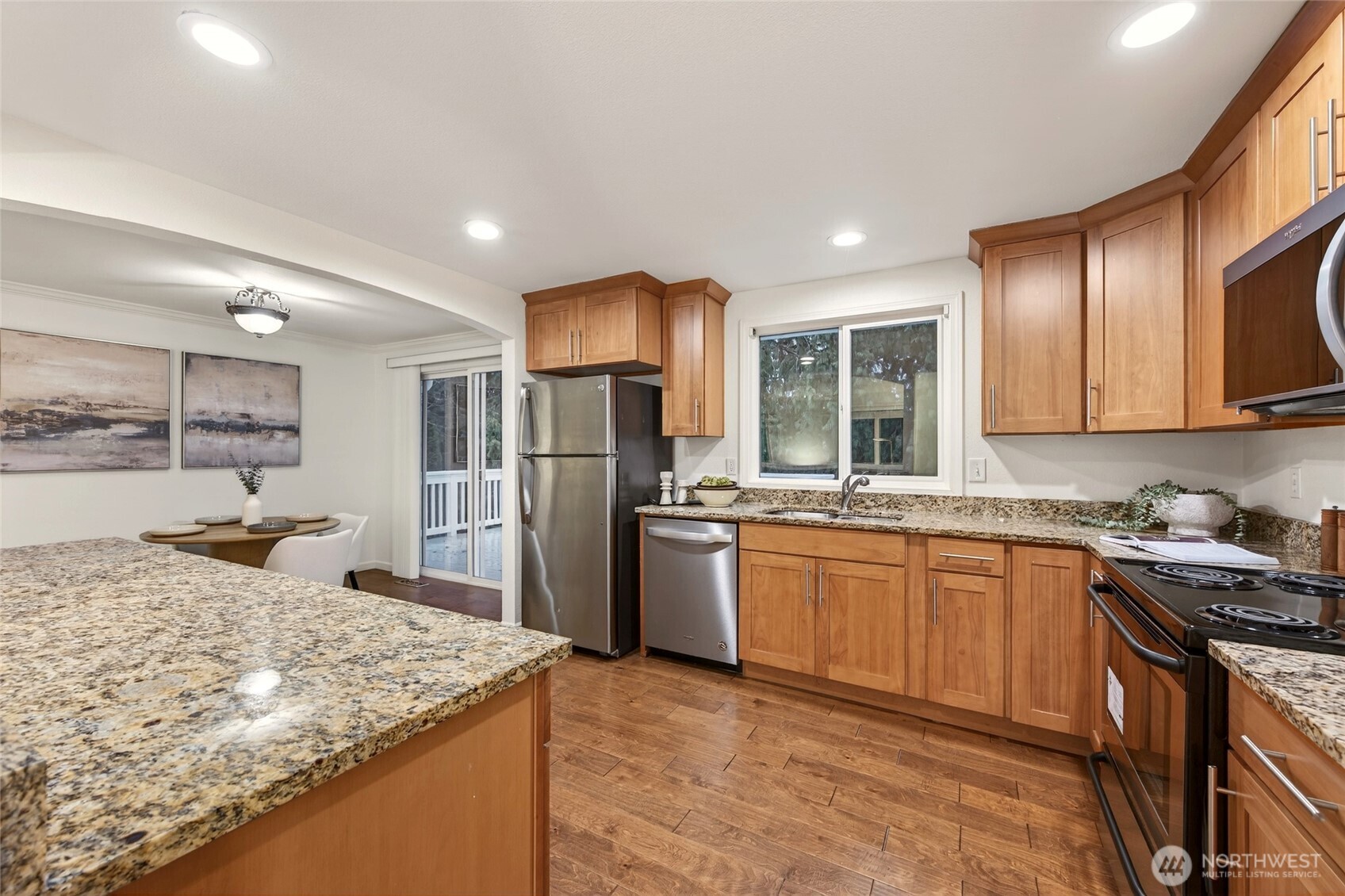Kitchen features granite countertops and stainless steel appliances