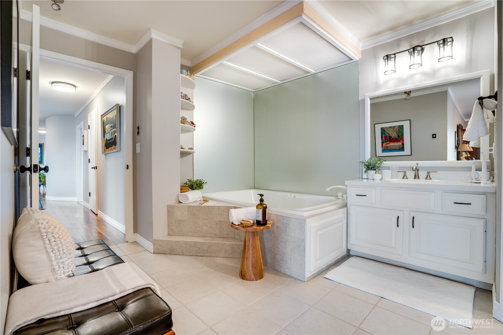 A spa-inspired primary bath offers a separate soaking tub, glass-enclosed shower, and an additional vanity.