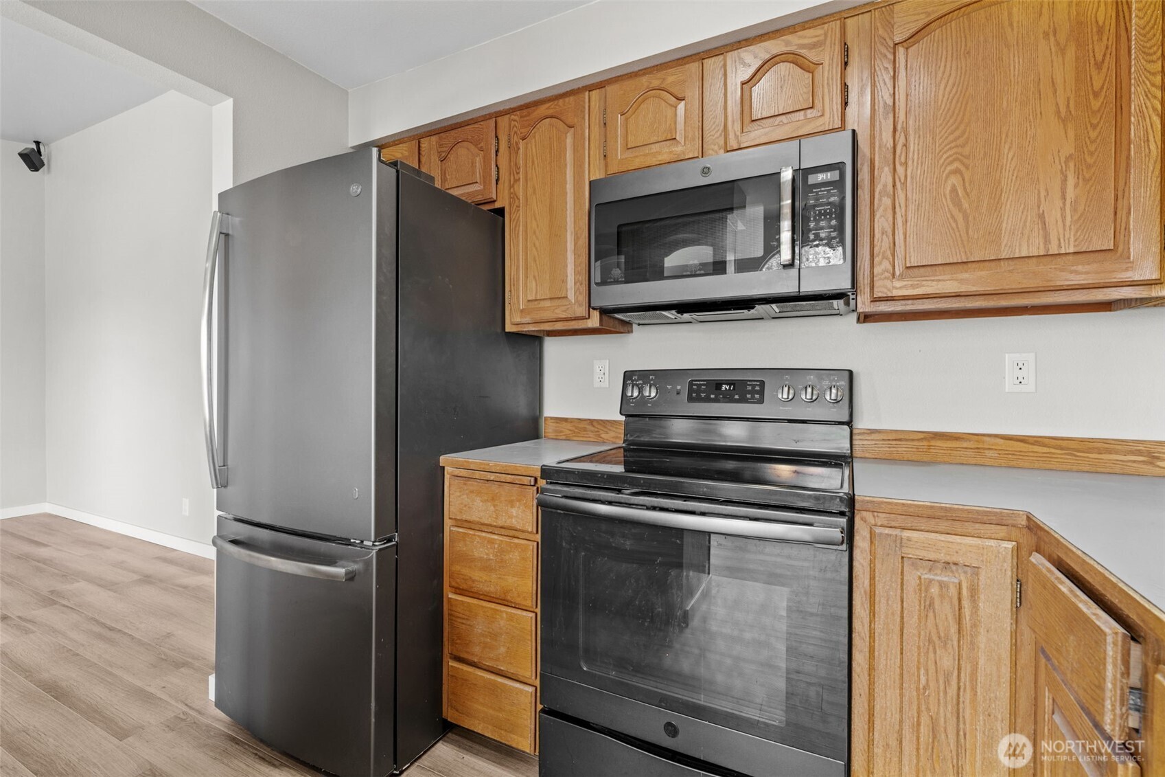 Kitchen opens to dining room with garden windows.