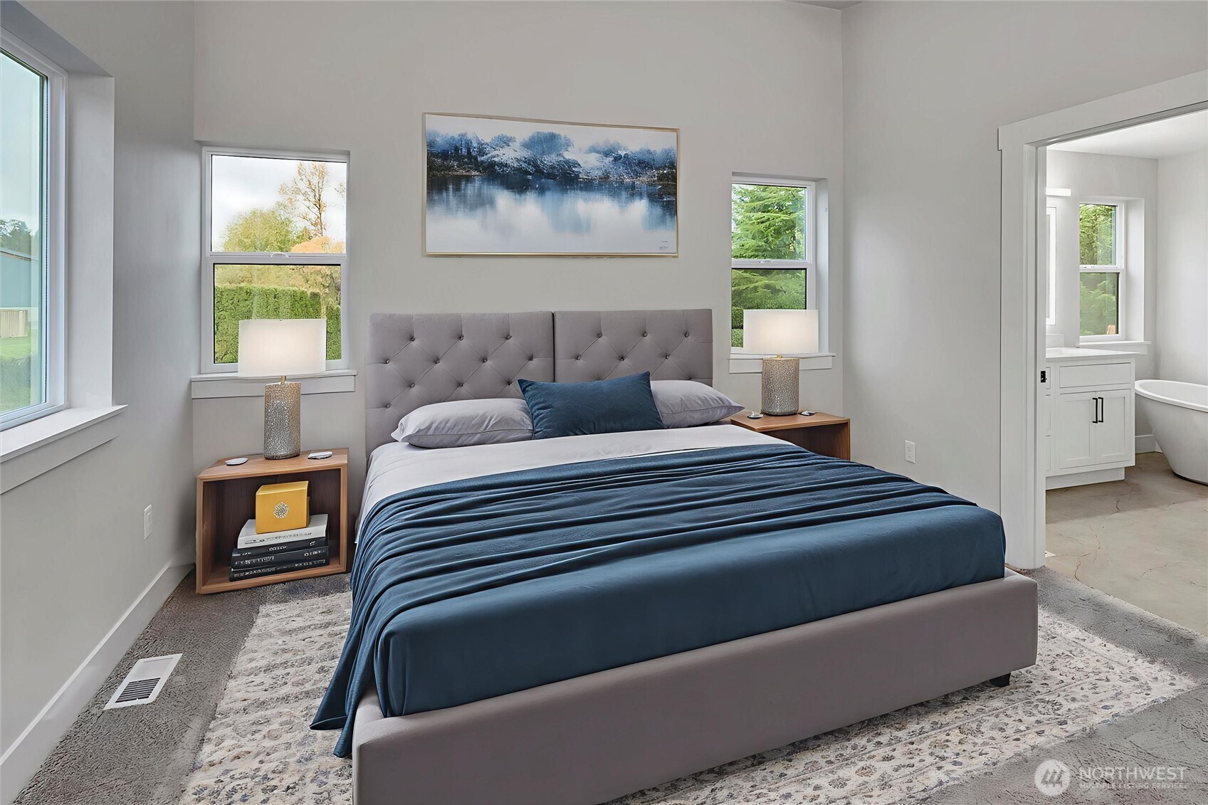 Primary bedroom with vaulted ceilings and lots of natural light. Virtually staged