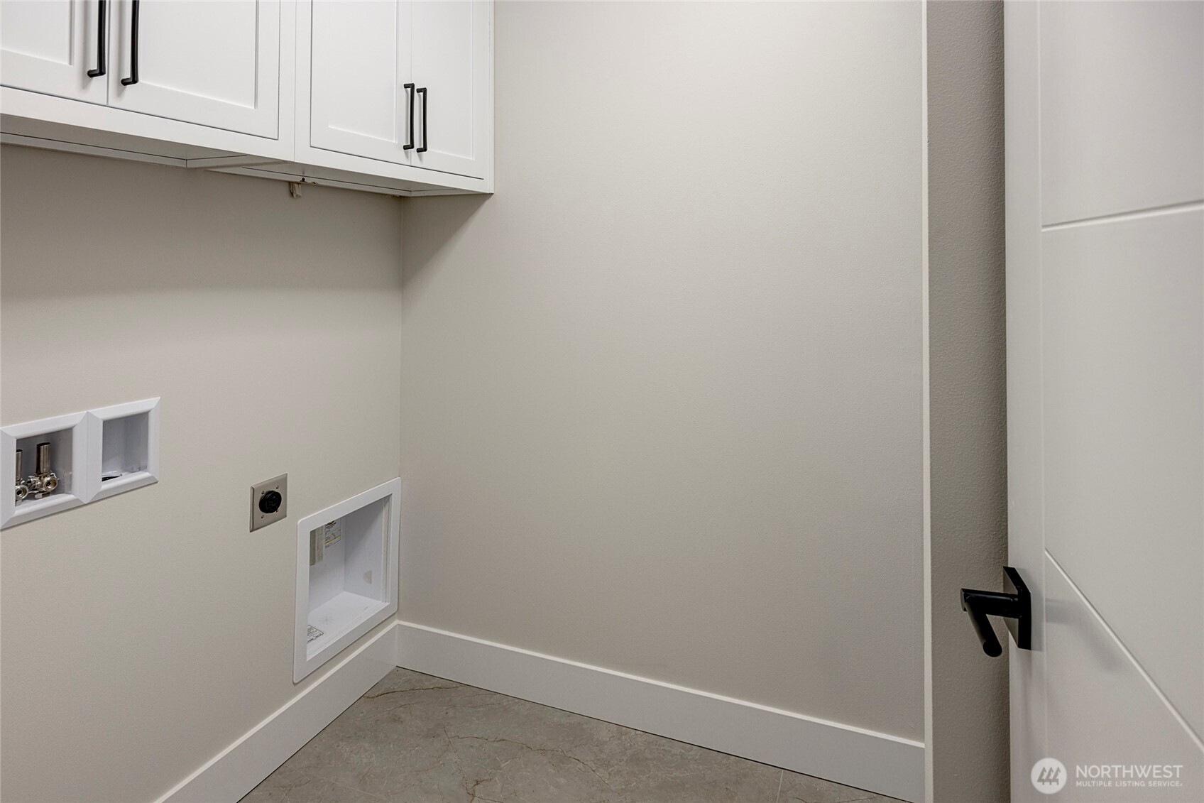 Laundry room on upper floor with built in cabinets and sink