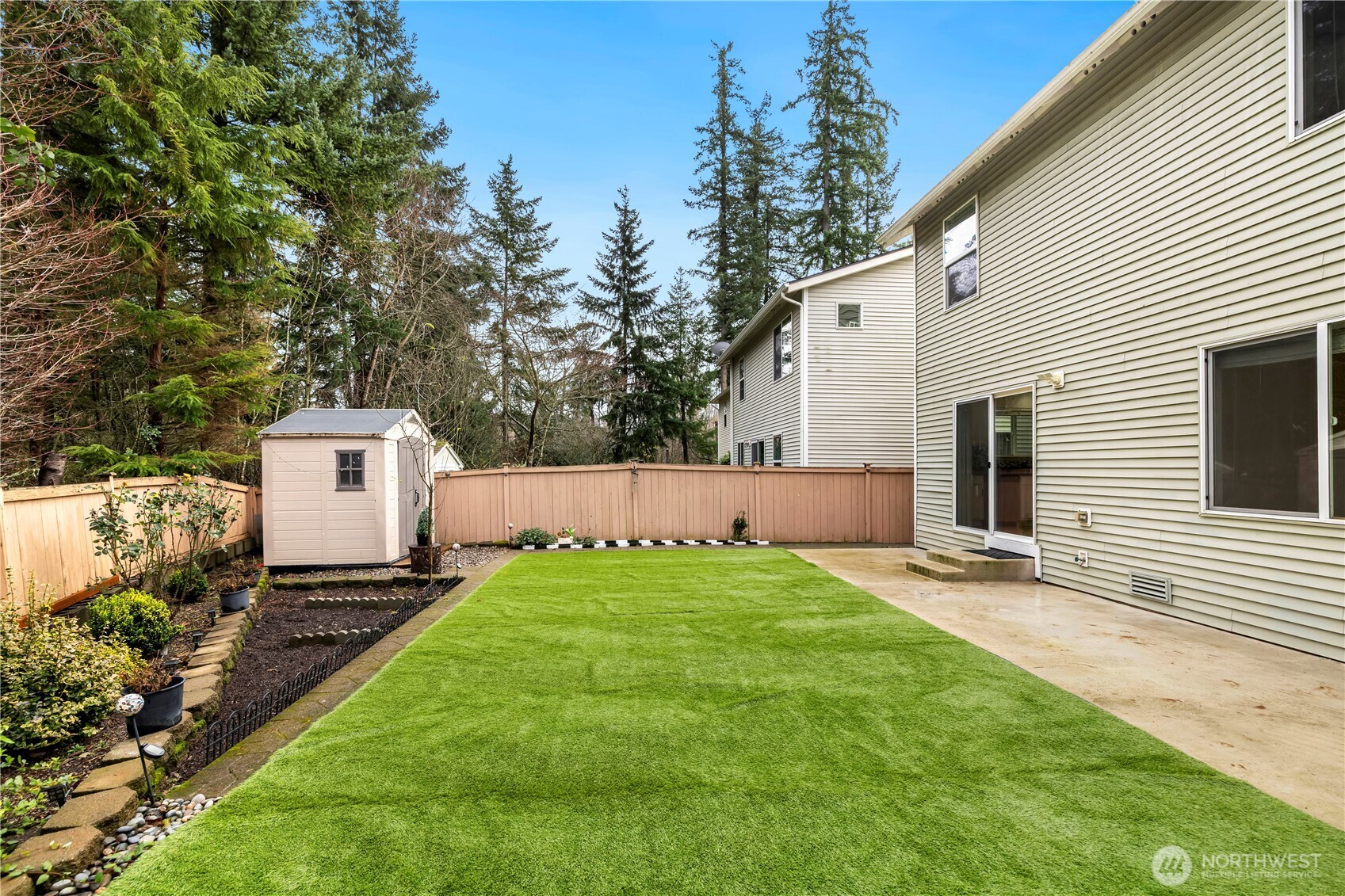 Another angle of the fully fenced backyard against the seclusive green belt.